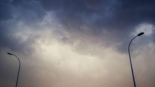 Low angle view of street light against cloudy sky