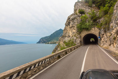 Road by mountain against sky