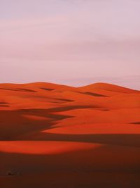 Scenic view of desert against sky during sunset