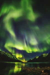 Scenic view of lake against sky at night