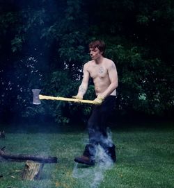 Full length of shirtless man standing in water