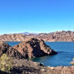 Scenic view of mountains against clear blue sky