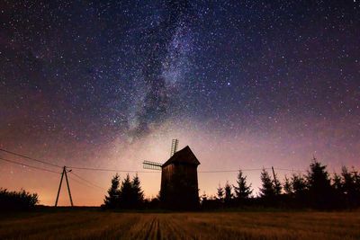 Built structure on field against sky at night