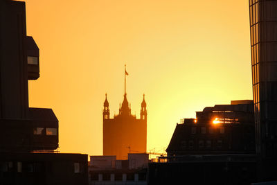 Silhouette of buildings against sky during sunset