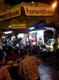 People at market stall in city