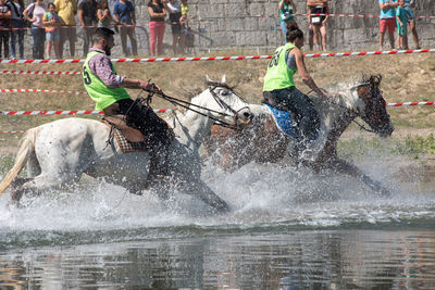 People in water splashing