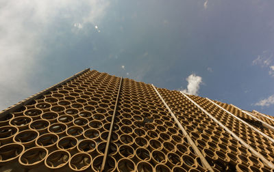 Low angle view of building against cloudy sky