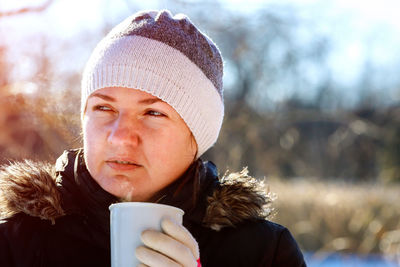Close-up of woman holding coffee cup during winter