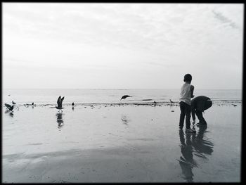 View of people standing on beach