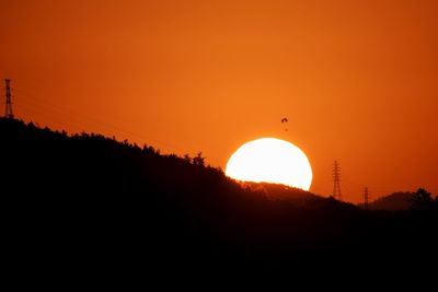 Silhouette of landscape against sunset sky