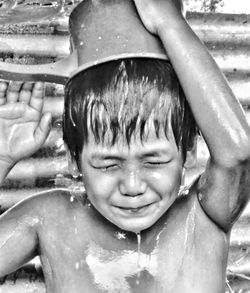 Shirtless boy taking bath