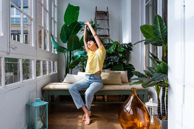 Portrait of young woman stretching arms