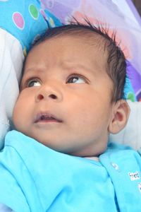 Portrait of cute baby lying on bed