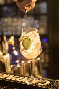 Cropped image of bar tender making cocktail