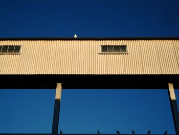 Low angle view of built structure against clear blue sky