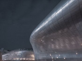 Low angle view of illuminated building against clear sky at night