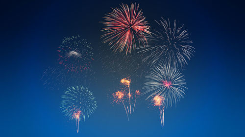 Low angle view of firework display at night