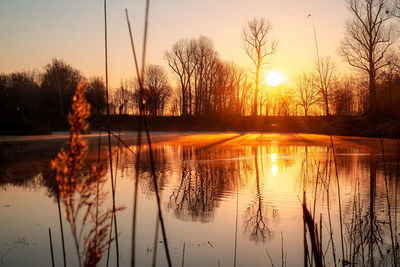 Scenic view of lake against sky during sunset