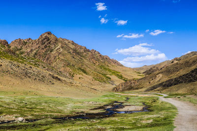 Scenic view of mountains against blue sky