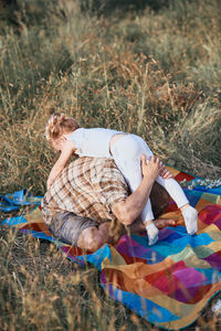 High angle view of woman lying on grass