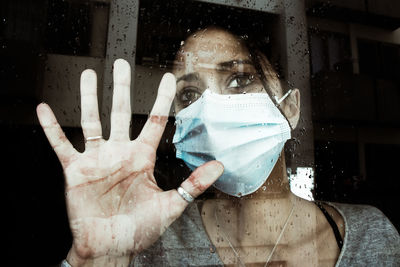 Portrait of woman wearing mask at home