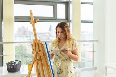 Woman painting at home