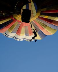 Low angle view of hot air balloon against clear blue sky