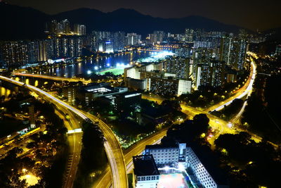 High angle view of city lit up at night