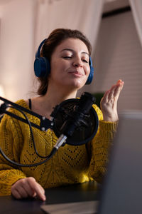 Portrait of young woman working at home