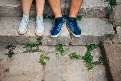 Low section of people sitting on stairs