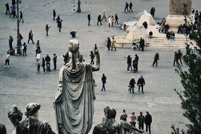 High angle view of statues and people at town square