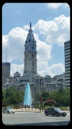Buildings against cloudy sky