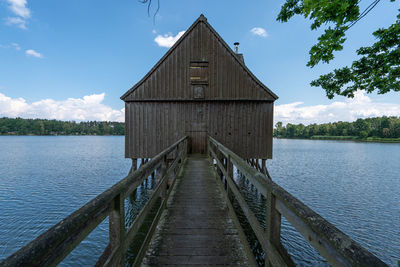 Pier over lake against sky