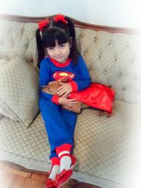 Close-up of boy sitting on sofa