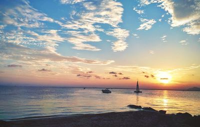 Scenic view of seascape against sky at sunset