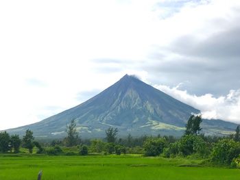 Scenic view of mountains against cloudy sky