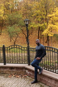 Full length of man standing on footbridge