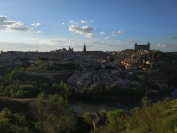 Aerial view of buildings in city against sky