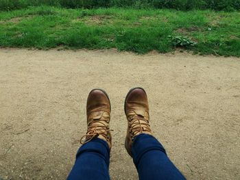 Low section of man standing on grass