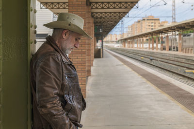 Portrait of adult man on cowboy hat waiting in train station. almeria, spain