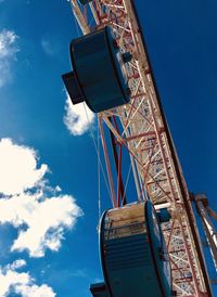 Low angle view of ferris wheel against blue sky