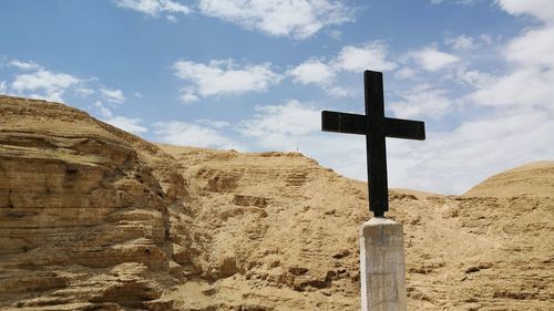 Cross in the judean desert in palestine with mountains panorama