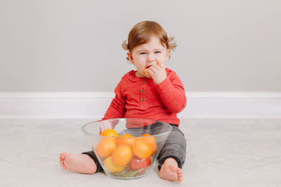 Cute boy with orange fruits