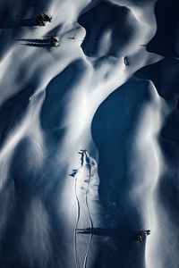 Aerial photo of two adults backcountry powder skiing in the kootenays, b.c., canada