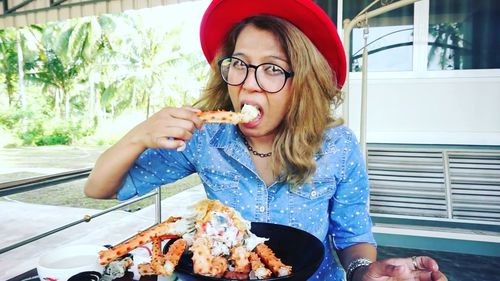 Portrait of woman eating crab leg