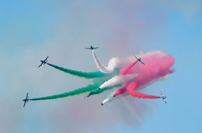 Low angle view of airplane flying against sky