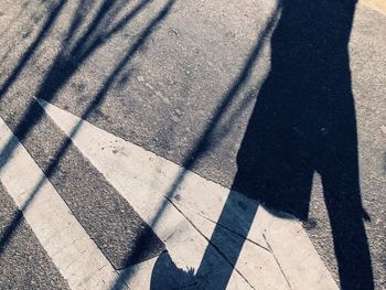 Low section of person shadow on tiled floor