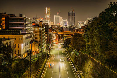 High angle view of illuminated buildings in city at night