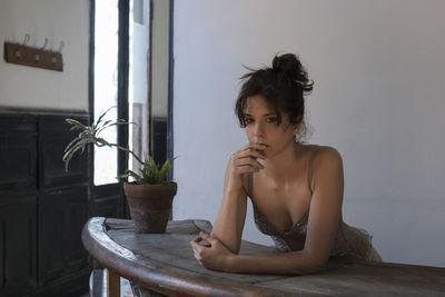 Young woman sitting on table