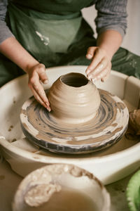 Hands creating ceramic mould from clay in potters workshop
